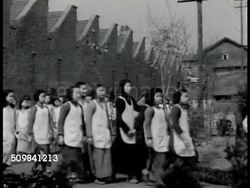 1944: CHINESE COTTON: Teenage girls in uniform, dress, apron, walking to textile mill. HA WS Girls, young women working at machines in cotton mill. MS Young adult females monitor machine w/ turning wheel. WWII, People's Republic of China. Instructional Video