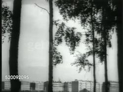 1935: MOSCOW IMPROVEMENTS: PAN Rows of modern State owned apartment buildings (communal dwellings, fixed rent). TD MS Apartment building windows, three stories. PAN Shanty, wooden shacks. Russia, Communism, lifestyle, improved conditions, propaganda. Instructional Video