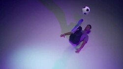 young male soccer freestyler juggling a ball on his brines Stock Footage
