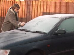 De-Icing a car on  frosty morning - HD & PAL Stock Footage