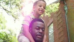 MS LA Smiling young boy riding on fathers shoulders on summer afternoon Stock Footage