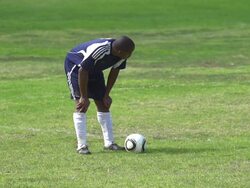 A man playing soccer on a grassy field. - Slow Motion - filmed at 240 fps Stock Footage