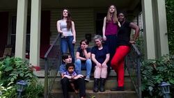 MS Married lesbian couple with family on front porch of home on summer evening Stock Footage