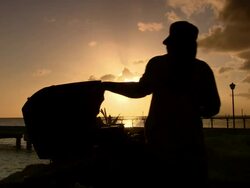 MS Shot of Man barbequing with sunset / Bridgetown, Saint Michael, Barbados Stock Footage