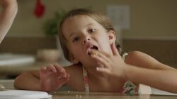 Close up shot of girl licking cookie dough from fingers / Orem, Utah, United States Stock Footage