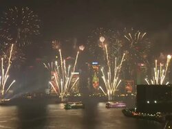 Large fireworks and sparks rain down over Hong Kong's Victoria Harbour, East Asian Games Opening Ceremony Fireworks Display, December 2009 Stock Footage