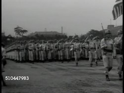 1948: KOREA & U.S. ARMY: EXT WS Korean soldiers in class. MS US officer showing artillery shell. WS U.S. Soldiers parading in formation. MS Gen. Douglas MacArthur saluting. Russian Soviet Dictator Joseph Stalin superimposed over US troops marching. Instructional Video