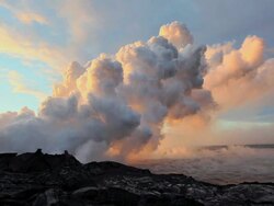 WS PAN View of sun rise with steam rising from volcanic vent and moving over ocean / Kalapana, Hawaii, USA Stock Footage