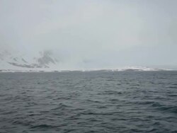 Cloudy and stormy weather at Isfjorden, the second longest fjord in the Norwegian archipelago of Svalbard; mountains covered by snow Stock Footage
