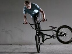 Male on bicycle performing tailwhip trick Stock Footage