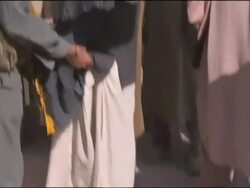 Afghan men being searched by Afghan Soldiers before attending a meeting Stock Footage