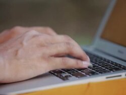 ECU Hands of a Buddhist monk typing on a laptop computer in an ancient temple in Angkor Wat / Siem Reap, Cambodia Stock Footage