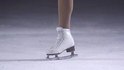 SLO MO Female figure skater performing catch foot spin Stock Footage