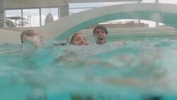 Friends playing in swimming pool Stock Footage
