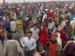 WS PAN Ganga Mela festival people crowding on river bank and some wading into water / India Stock Footage