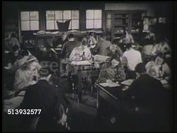 1952: MEDICAL SCHOOL:  HA WS Professor in lab coat walking through medical class (could be biology) w/ students at lab desks w/ microscopes. MS Female taking notes, looking into microscope, pulling out slide, taking notes. Doctors, medicine, science Instructional Video