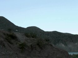 Camera panning to show four mountain bikers on top of hill Stock Footage