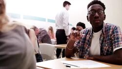 Pensive boy taking test in classroom Stock Footage