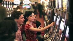 Young guy wins big at casino slot machine, celebrates with friends Stock Footage