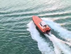 Generic pilot boat joining the ship to help entering harbor Stock Footage