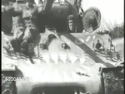 1951: KOREAN WAR: U.S. FORCES: VS United States M4 Sherman tanks rolling along on field w/ Marines riding on top, tracks moving through mud, entering war torn city of Seoul, Marines walking, taking down China Red Communist flag. 38th Parallel Instructional Video
