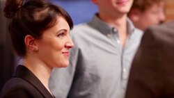 MS Smiling woman talking with friends during dinner party Stock Footage