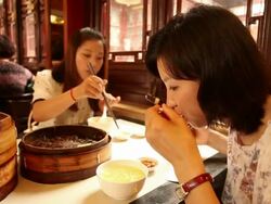 Woman eating Xiaolongbao in restaurant Stock Footage
