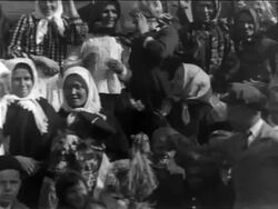 B/W 1900s close up PAN crowd of immigrants smiling + posing for camera / NYC / newsreel Stock Footage