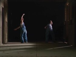 two dancers coming in from darkness and then dancing together Stock Footage