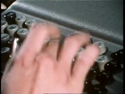 A woman's hand types on a typewriter. News Clip