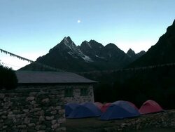 Blue and red tents near a stone building in the Himalayas. Stock Footage