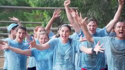 Portrait of enthusiastic team getting sprayed with water on boot camp obstacle course Stock Footage