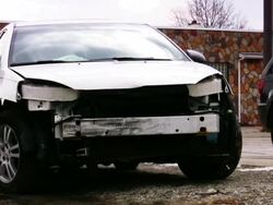 Car wreck remains near body shop. Damaged automobile vechicle. Stock Footage