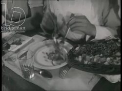Girls and cook's apprentices eating lunch. A teacher talks to a student. France, 1942 Stock Footage