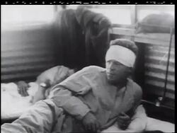 B/W 1960s wounded soldier with bandage on head lying on bed in military hospital / Vietnam War Stock Footage