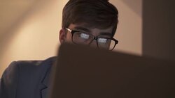 Using laptop, screen reflection in eyeglasses. Stock Footage