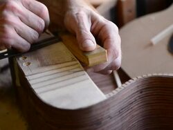 Craftsman 'Luthier' Nigel Forster making hand made Guitars Stock Footage
