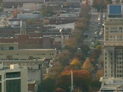 MS AERIAL Shot of traffic on road between buildings in Augusta city / Georgia, United States Stock Footage