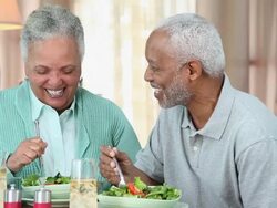 MS DS Senior Couple Eating Salad at Home Dining Room Table / Richmond, Virginia, USA Stock Footage