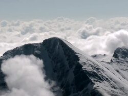 AERIAL clouds and snow-covered peaks of the Rocky Mountains / Kalispell, Montana Stock Footage