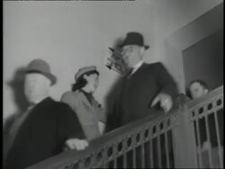 People walk down stairs on their way to an air raid shelter. News Clip