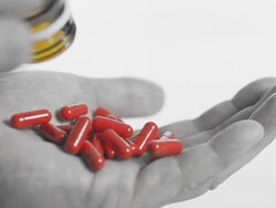 HD SLOW MOTION: Pouring Red Capsules Stock Footage