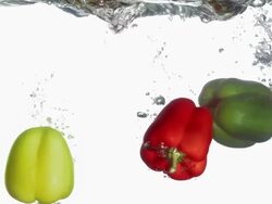 HD Super Slow-Mo: Bell Peppers Falling Into Water Stock Footage