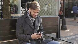 Young male texting on smart phone Stock Footage