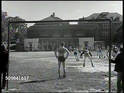 1945: HYATTSVILLE HIGH SCHOOL SOCCER FIELD:  (POV behind goal keeper) WS High school students in recreational uniforms playing soccer on field. WS Students chasing after soccer ball. Recreation, gym, football, sport. Maryland Instructional Video