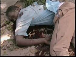 WRAP GRAPHIC Soldiers' bodies burning, dead civilians, US amb; street scenes News Clip