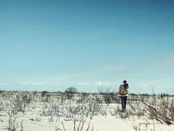 Backpacker walking through the desert Stock Footage