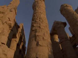 Low Angle, pan-right - Spires of old adobe buildings stand against a clear blue sky / Egypt Stock Footage