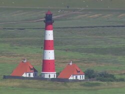 MS AERIAL Shot of Westerhever Leuchtturm / Sankt Pete Ording, Schleswig Holstein Stock Footage