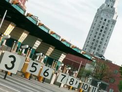 Time lapse, toll booth exits, multiple cars and traffic drive away down the interstate highway. Stock Footage